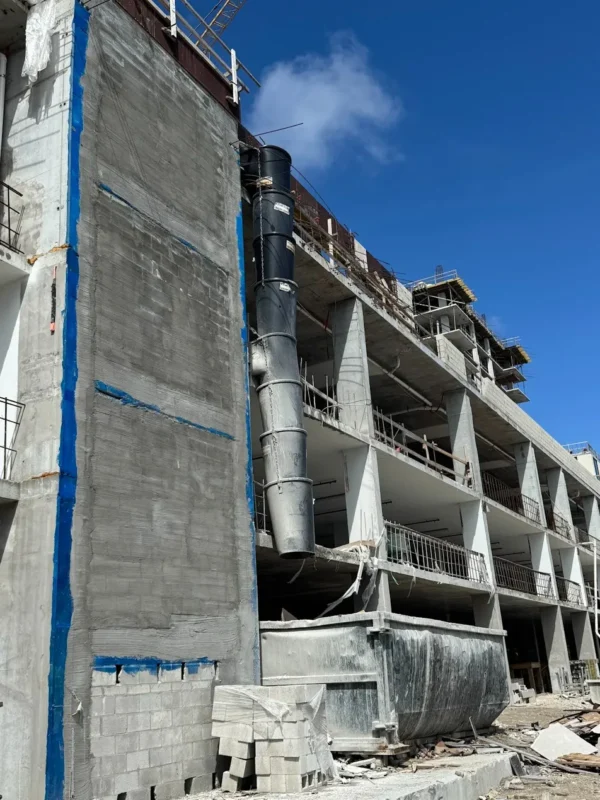 construction trash chute system installed on a multi-story building for safe and efficient debris removal