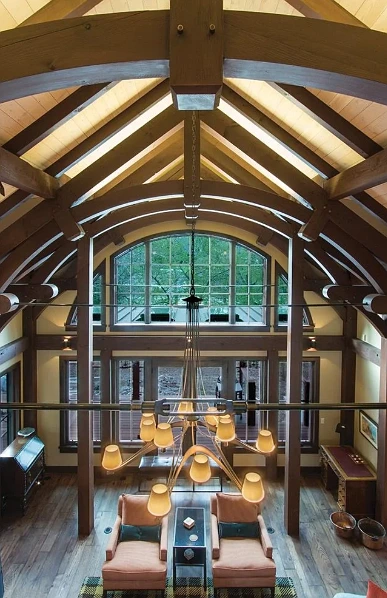 Timber frame interior highlighting handcrafted joinery and beams.