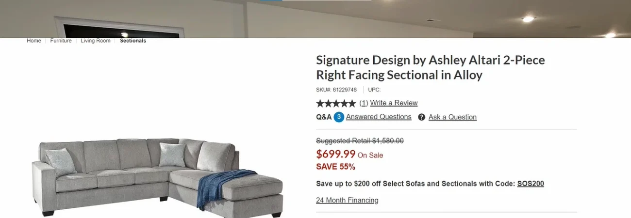 Full wide shot of her large grey traditional sectional on the other side of the room